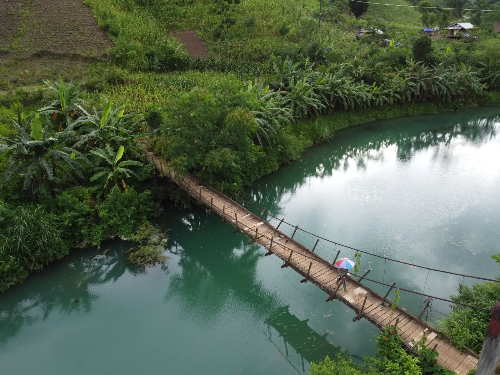 Crossing the river on a cane bridge