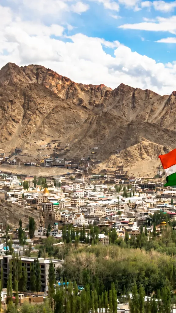 Indian national flag overlooking Leh city and rugged Ladakh mountains